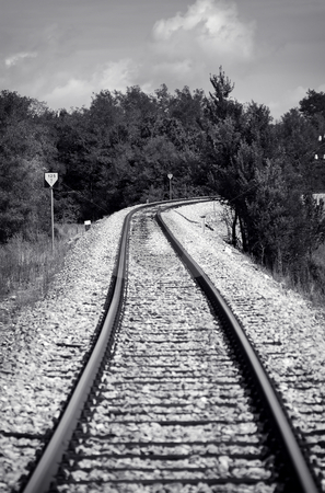 To use this stock image in your creative project, please select the size you need over to the right and click the "Add to Cart" button.
Your downloaded image will come with the Cutcaster watermark removed so don’t worry about the watermark you see on this page. Railway stock photo, Black and white old style photo of a train railway by Gordan Poropat