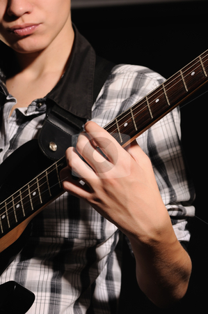 To use this stock image in your creative project, please select the size you need over to the right and click the "Add to Cart" button.
Your downloaded image will come with the Cutcaster watermark removed so don’t worry about the watermark you see on this page. Guitarist stock photo, The guitarist plays on a guitar shooting closeup by Salauyou Yury