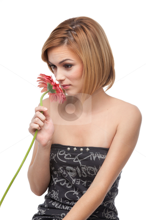 Portrait of a young woman smelling a flower Portrait of a young woman smelling a flower stock photo, A portrait of a young, blonde woman, smelling a red flower and smiling by dan comaniciu