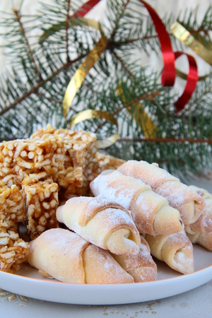 To use this stock image in your creative project, please select the size you need over to the right and click the "Add to Cart" button.
Your downloaded image will come with the Cutcaster watermark removed so don’t worry about the watermark you see on this page. Cookies for a holiday stock photo, Cookies for a holiday on a plate with tree branches by Olga Kriger