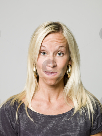 To use this stock image in your creative project, please select the size you need over to the right and click the "Add to Cart" button.
Your downloaded image will come with the Cutcaster watermark removed so don’t worry about the watermark you see on this page. Portrait of a woman making a funny face stock photo, Portrait of a woman making a funny face by Anne-Louise Quarfoth