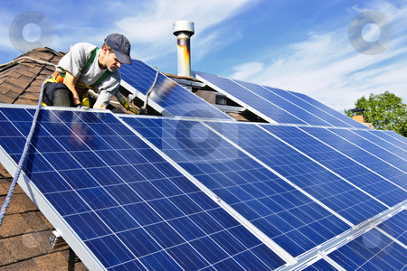 Solar panel installation Solar panel installation stock photo, Man installing alternative energy photovoltaic solar panels on roof by Elena Elisseeva