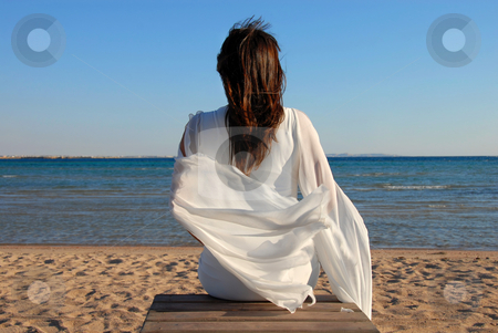 To use this stock image in your creative project, please select the size you need over to the right and click the "Add to Cart" button.
Your downloaded image will come with the Cutcaster watermark removed so don’t worry about the watermark you see on this page. Woman sitting on beach stock photo, Woman in white dress back sitting on beach by sea by Julija Sapic