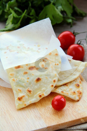 To use this stock image in your creative project, please select the size you need over to the right and click the "Add to Cart" button.
Your downloaded image will come with the Cutcaster watermark removed so don’t worry about the watermark you see on this page. Indian nan bread on a wooden board stock photo, by Olga Kriger