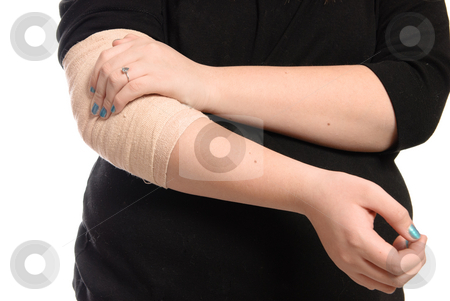 Elbow Injury Elbow Injury stock photo, A young girl is holding her elbow which is wrapped in a tensor bandage, isolated against a white background. by Richard Nelson