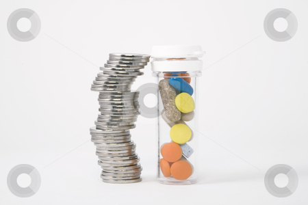 Money and pills Money and pills stock photo, Piled up money next to a bottle of colored pills by Victor Oancea
