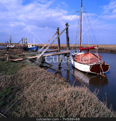 To use this stock image in your creative project, please select the size you need over to the right and click the "Add to Cart" button.
Your downloaded image will come with the Cutcaster watermark removed so don’t worry about the watermark you see on this page. Fenland stock photo, Boats moored on the Lincolnshire fens by Paul Phillips