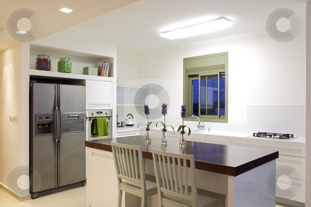 To use this stock image in your creative project, please select the size you need over to the right and click the "Add to Cart" button.
Your downloaded image will come with the Cutcaster watermark removed so don’t worry about the watermark you see on this page. New kitchen in a modern home stock photo, Modern design kitchen with white and wood elements by Dmitry Pistrov