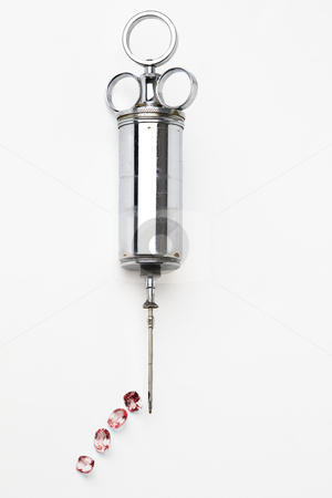 Blood Stone Blood Stone stock photo, red gemstome dripping out of a vintage vetenarian syringe against white background by Yann Poirier