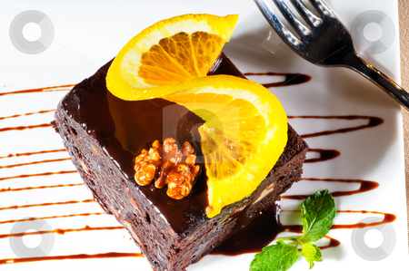 To use this stock image in your creative project, please select the size you need over to the right and click the "Add to Cart" button.
Your downloaded image will come with the Cutcaster watermark removed so don’t worry about the watermark you see on this page. Chocolate and walnuts cake stock photo, fresh baked delicious chocolate and walnuts cake with slice of orance on top and mint leaf by Francesco Perre