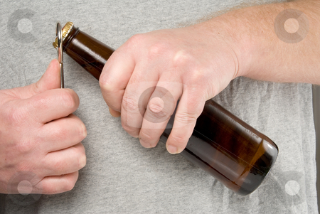 To use this stock image in your creative project, please select the size you need over to the right and click the "Add to Cart" button.
Your downloaded image will come with the Cutcaster watermark removed so don’t worry about the watermark you see on this page. Opening a Beer stock photo, A person using a bottle opener to open a beer. by Robert Byron