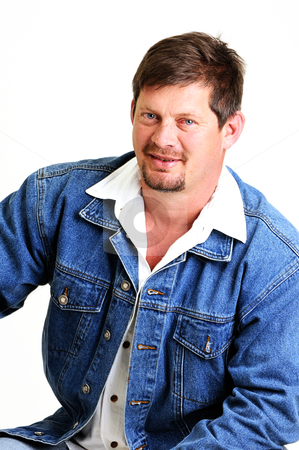 To use this stock image in your creative project, please select the size you need over to the right and click the "Add to Cart" button.
Your downloaded image will come with the Cutcaster watermark removed so don’t worry about the watermark you see on this page. Portrait of handsome male model with beard stock photo, portrait of handsome male model with beard and smiling wearing a jeans jacket by Ansunette