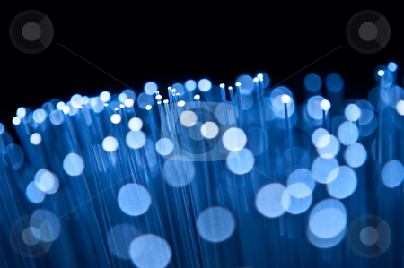 Optical abstract Optical abstract stock photo, Close up on the ends of many illuminated blue fibre optic strands with many unfocussed bokeh effects against black background. by Samantha Craddock