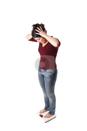 Shock at the results Shock at the results stock photo, Pretty brunette looking shocked because she gained another pound by Simone Van den Berg