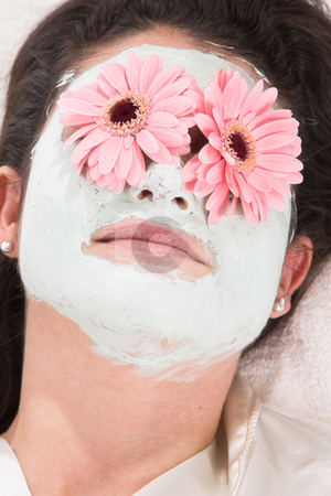 To use this stock image in your creative project, please select the size you need over to the right and click the "Add to Cart" button.
Your downloaded image will come with the Cutcaster watermark removed so don’t worry about the watermark you see on this page. Beauty treatment stock photo, Pretty brunette lying on a towel with a claymask and flowers on her eyes by Simone Van den Berg