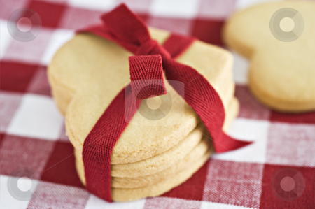 To use this stock image in your creative project, please select the size you need over to the right and click the "Add to Cart" button.
Your downloaded image will come with the Cutcaster watermark removed so don’t worry about the watermark you see on this page. Heart shaped cookies with a red ribbon stock photo, Heart shaped cookies with a red ribbon by tish1