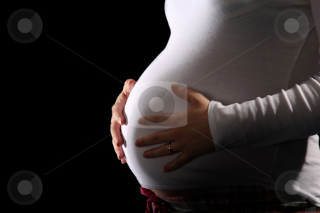 Pregnant woman holding belly Pregnant woman holding belly stock photo, pregnant woman holding belly on black background by vladacanon1