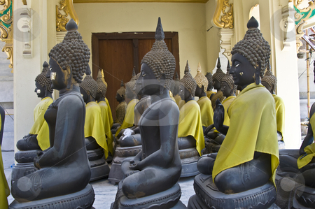 Buddha Buddha stock photo, lots of statues of buddha sitting in lines by Juliane Jacobs