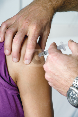 Immunization Immunization stock photo, Doctor giving an injection to a young female in the doctors office. Focus is on the syringe. by © Ron Sumners