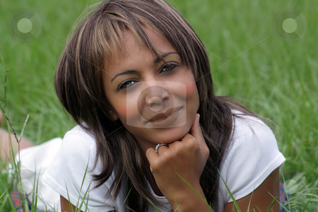 Woman in a Grassy Field (2) Woman in a Grassy Field (2) stock photo, Close-up of a lovely mature black woman in a grassy field, looking into the camera with a pleasant smile. by Carl Stewart