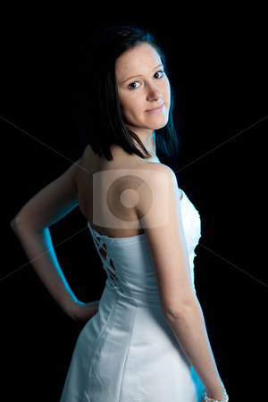 To use this stock image in your creative project, please select the size you need over to the right and click the "Add to Cart" button.
Your downloaded image will come with the Cutcaster watermark removed so don’t worry about the watermark you see on this page. Young woman dress back blue light stock photo, a young woman in a white dress looking backward over her shoulder lit by blue backlight by Jerax