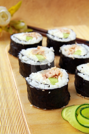 To use this stock image in your creative project, please select the size you need over to the right and click the "Add to Cart" button.
Your downloaded image will come with the Cutcaster watermark removed so don’t worry about the watermark you see on this page. Traditional Japanese food maki rolls on a wooden board stock photo, Traditional Japanese food maki rolls on a wooden board by Olga Kriger