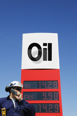 To use this stock image in your creative project, please select the size you need over to the right and click the "Add to Cart" button.
Your downloaded image will come with the Cutcaster watermark removed so don’t worry about the watermark you see on this page. Oil-sign with engineer in foreground stock photo, engineer, worker talking in phone, large informative oil-sign in background, as seen inside the industry by lagereek