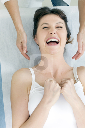 To use this stock image in your creative project, please select the size you need over to the right and click the "Add to Cart" button.
Your downloaded image will come with the Cutcaster watermark removed so don’t worry about the watermark you see on this page. Young caucasian woman lying down smiling and receiving head massage stock photo, young caucasian woman lying down smiling and receiving head massage by ambrophoto