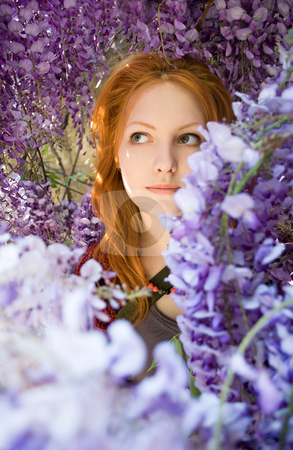 Spring beauty among flowers. Spring beauty among flowers. stock photo, Romantic portrait of beautiful young redhead girl among spring lilac flowers. by exvivo