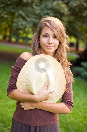 To use this stock image in your creative project, please select the size you need over to the right and click the "Add to Cart" button.
Your downloaded image will come with the Cutcaster watermark removed so don’t worry about the watermark you see on this page. Pretty young brunette dancing in nature. stock photo, Pretty young spring brunette hugging her straw hat. by exvivo