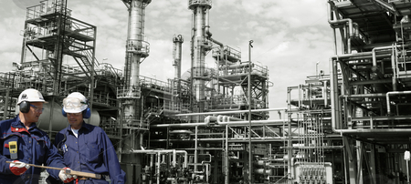 Oil workers and power industry Oil workers and power industry stock photo, engineers, oil-workers with large oil and gas refinery in background, panoramic view by lagereek