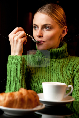 To use this stock image in your creative project, please select the size you need over to the right and click the "Add to Cart" button.
Your downloaded image will come with the Cutcaster watermark removed so don’t worry about the watermark you see on this page. Young woman with a spoon in her mouth making breakfast with a cup of cappuccino and croissant stock photo, young woman with a spoon in her mouth making breakfast with a cup of cappuccino and croissant by ambrophoto