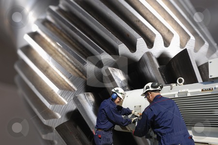 To use this stock image in your creative project, please select the size you need over to the right and click the "Add to Cart" button.
Your downloaded image will come with the Cutcaster watermark removed so don’t worry about the watermark you see on this page. Steel and metal engineering stock photo, engineers, working with large gear wheels machinery, titanium and steel works by lagereek