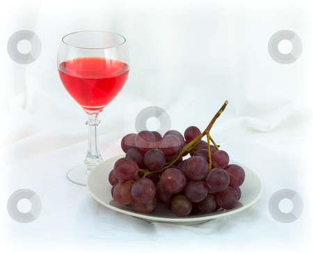 Still-life with a glass of red wine and grapes Still-life with a glass of red wine and grapes stock photo, Still-life with a glass of red wine and grapes on a white background by Alexey Romanov