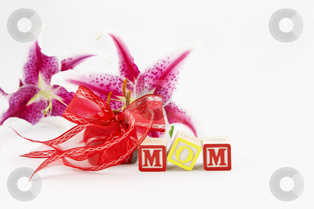 Mom, So Special Mom, So Special stock photo, Alphabet blocks spelling out MOM are in front of a red ribbon wrapped gift and two, single lily blooms, all placed on a white background. by Florence McGinn