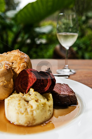 To use this stock image in your creative project, please select the size you need over to the right and click the "Add to Cart" button.
Your downloaded image will come with the Cutcaster watermark removed so don’t worry about the watermark you see on this page. Roast Beef stock photo, A roast beef with mash potato, yorkshire pudding, beetroot chips, gravy and a glass of white wine. by thisboy