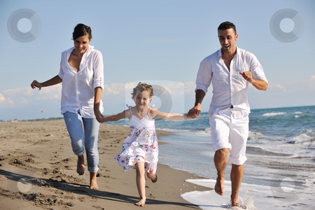 Happy young family have fun on beach Happy young family have fun on beach stock photo, happy young family in white clothing have fun at vacations on beautiful beach by Benis Arapovic