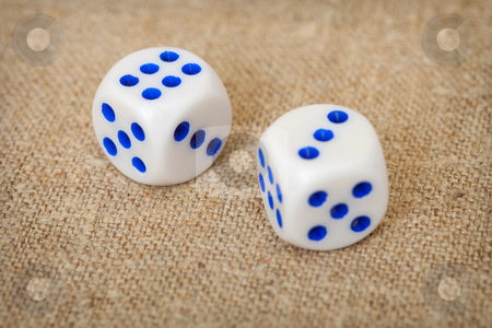 Two playing dices with blue points on brown canvas Two playing dices with blue points on brown canvas stock photo, Two playing dices with dark blue points lie on a brown canvas by Alexey Romanov