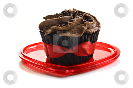 To use this stock image in your creative project, please select the size you need over to the right and click the "Add to Cart" button.
Your downloaded image will come with the Cutcaster watermark removed so don’t worry about the watermark you see on this page. Chocolate cupcake with red bow on a heart shaped plate stock photo, Chocolate cupcake with red bow on a heart shaped plate by tish1