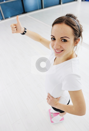 Happy diet concept with young woman on pink scale Happy diet concept with young woman on pink scale stock photo, happy diet concept with young woman on pink scale at sport fitnes gym club by Benis Arapovic