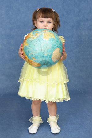 Little girl holding a large globe Little girl holding a large globe stock photo, Little girl holding a large globe on a blue background by Alexey Romanov