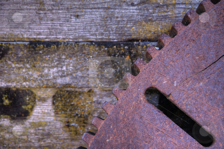 Iron Gear Iron Gear stock photo, Old rusted iron gear against wood background from old foundry by bobkeenan