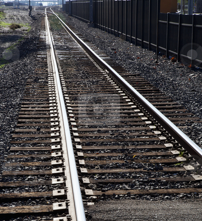 To use this stock image in your creative project, please select the size you need over to the right and click the "Add to Cart" button.
Your downloaded image will come with the Cutcaster watermark removed so don’t worry about the watermark you see on this page. Light Rail Tracks stock photo, City light rail tracks disappearing into distance with black metal fence by bobkeenan
