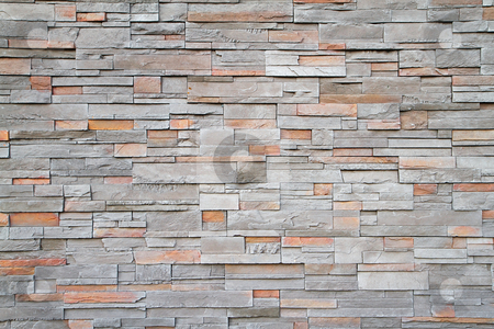 Square stone wall far Square stone wall far stock photo, Gray, brown, red flat stone wall in a random pattern by bobkeenan