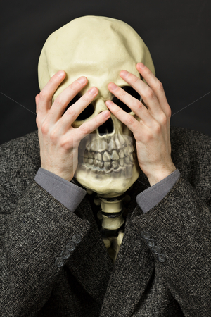 To use this stock image in your creative project, please select the size you need over to the right and click the "Add to Cart" button.
Your downloaded image will come with the Cutcaster watermark removed so don’t worry about the watermark you see on this page. Skeleton covering his eyes stock photo, Skeleton covering his eyes on a dark background by Alexey Romanov