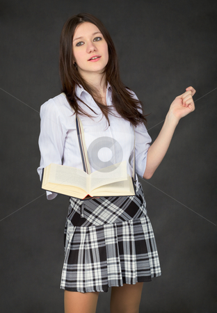 Girl with the book in hand on black Girl with the book in hand on black stock photo, Girl with the book in hand on black background by Alexey Romanov