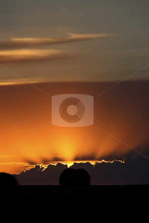 Setting sun peaking out from storm clouds in Saskatchewan Setting sun peaking out from storm clouds in Saskatchewan stock photo, Setting sun peaking out from storm clouds in Saskatchewan by Mark Duffy