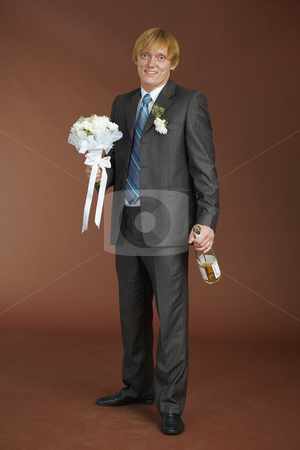 Groom with bouquet and bottle of sparkling wine Groom with bouquet and bottle of sparkling wine stock photo, A young groom with a bouquet and a bottle of sparkling wine by Alexey Romanov