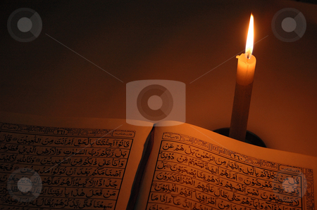 Holly quran Holly quran stock photo, holly quran with single candle light in dark room by Bayu Harsa