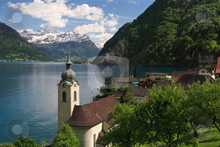 To use this stock image in your creative project, please select the size you need over to the right and click the "Add to Cart" button.
Your downloaded image will come with the Cutcaster watermark removed so don’t worry about the watermark you see on this page. Lake Lucerne from Bauen stock photo, Looking over the church in Bauen onto Lake Lucerne in Switzerland.
by © Ron Sumners